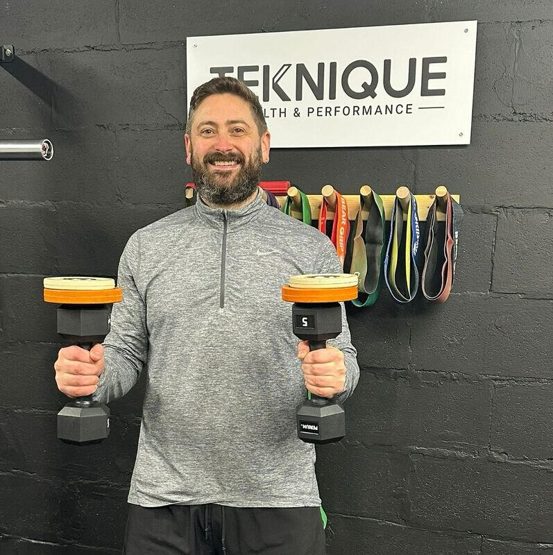 Damien holding weights Damien celebrating weight loss at teknique